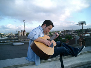 a man riffing on an acoustic guitar