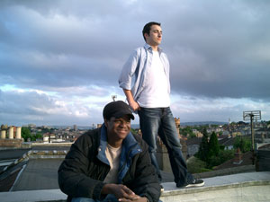 two men on a roof smiling